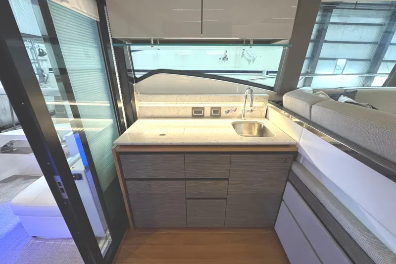 Slide: The Image of Modern kitchen area in 2020 Tiara Yachts C49 Coupe with sleek cabinetry and sink. - 27