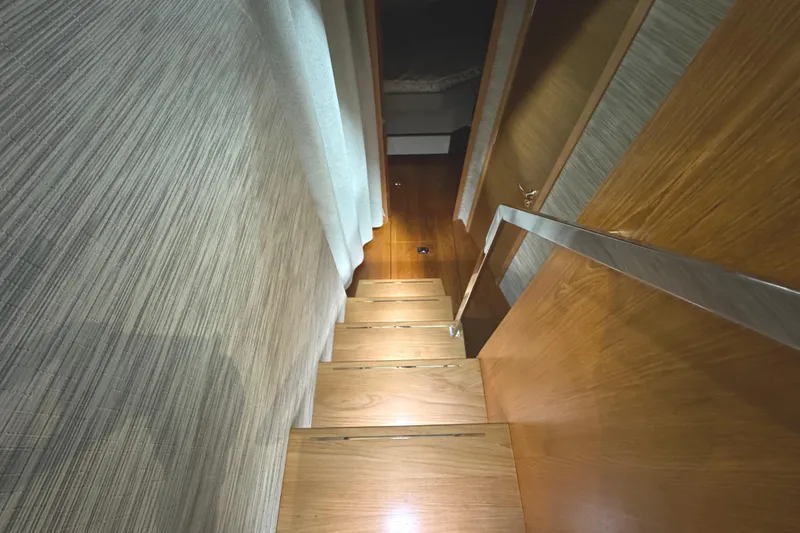Slide: The Image of Staircase inside 2020 Tiara Yachts C49 Coupe, featuring wooden steps and modern design. - 37