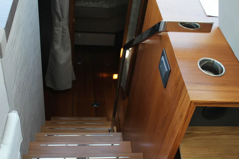 Slide: The Image of Interior stairs of 2020 Tiara Yachts C49 Coupe with wooden finish. - 38