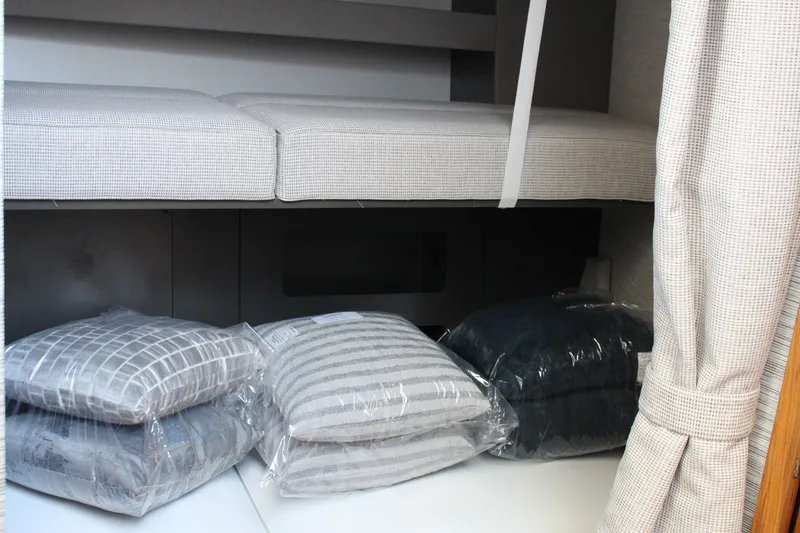 Slide: The Image of Interior of 2020 Tiara Yachts C49 Coupe with cushions and pillows in storage area. - 41