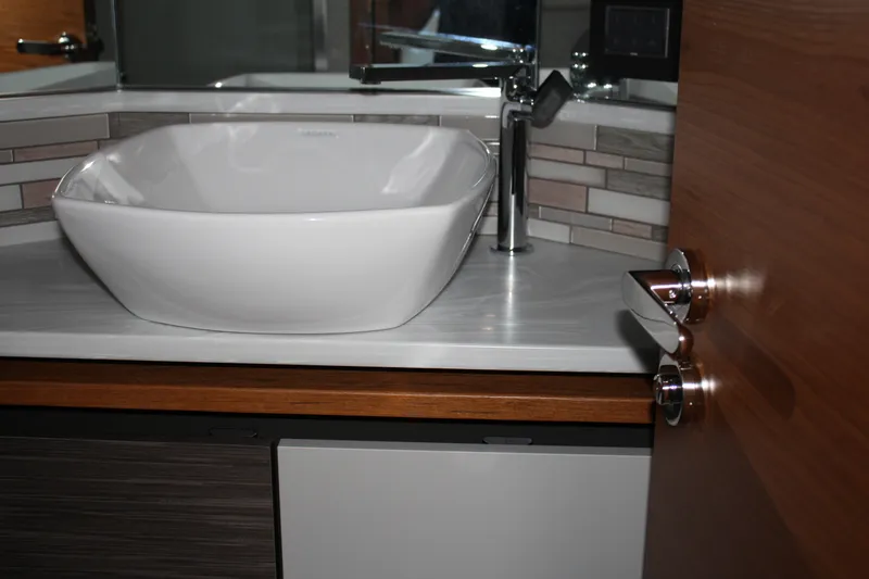 Slide: The Image of Modern bathroom sink in 2020 Tiara Yachts C49 Coupe, featuring sleek design and stylish fixtures. - 49