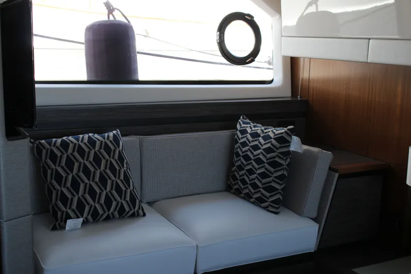 Slide: The Image of Interior of 2020 Tiara Yachts C49 Coupe with modern seating and geometric pillows. - 50