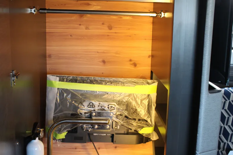 Slide: The Image of Interior of 2020 Tiara Yachts C49 Coupe with wrapped equipment and wooden paneling. - 51