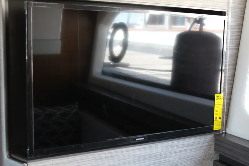 Slide: The Image of Flat-screen TV inside 2020 Tiara Yachts C49 Coupe, reflecting yacht interior. - 52