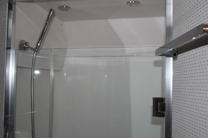 Slide: The Image of Shower area in 2020 Tiara Yachts C49 Coupe with glass door and modern fixtures. - 56