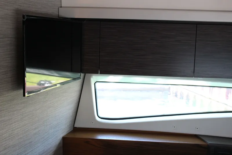 Slide: The Image of Interior of 2020 Tiara Yachts C49 Coupe with TV and window view. - 57