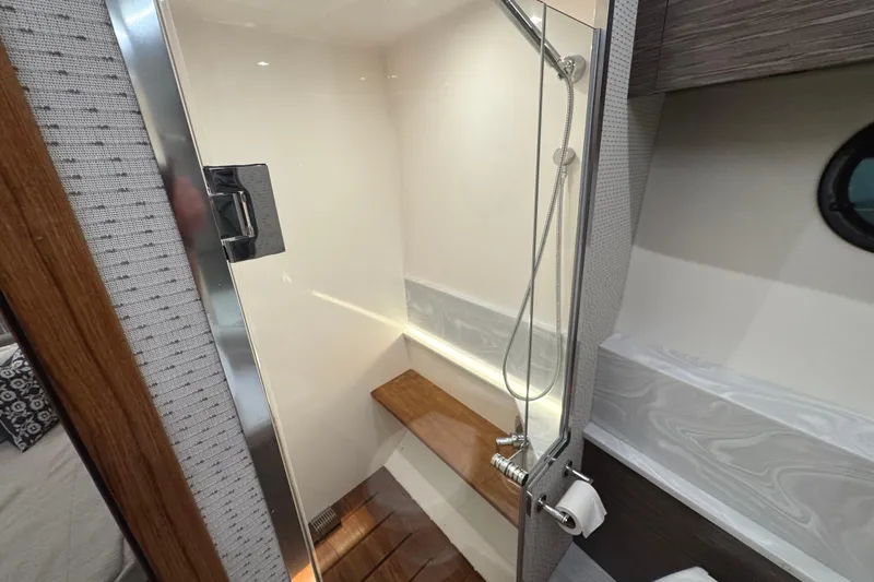 Slide: The Image of 2020 Tiara Yachts C49 Coupe shower area with modern design and wooden accents. - 62