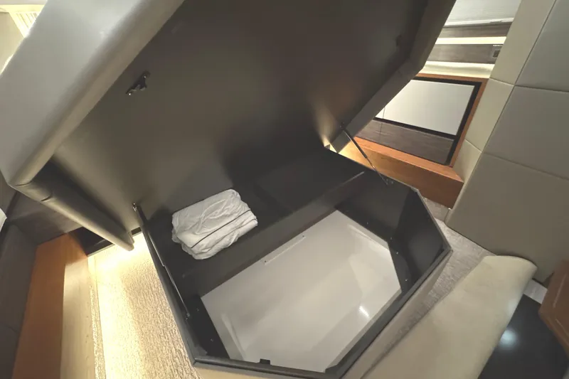 Slide: The Image of 2020 Tiara Yachts C49 Coupe interior storage compartment with folded linens. - 63
