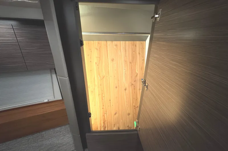 Slide: The Image of Interior view of 2020 Tiara Yachts C49 Coupe, featuring a wooden door and modern cabinetry. - 65