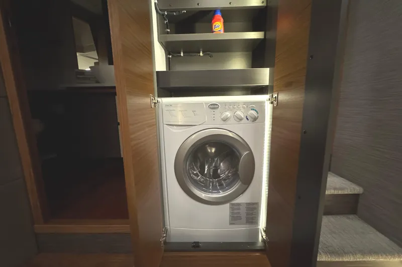 Slide: The Image of Washing machine in Tiara Yachts C49 Coupe 2020, with detergent on shelf. - 66