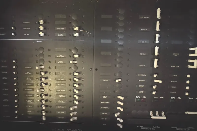Slide: The Image of Control panel of a 2020 Tiara Yachts C49 Coupe, featuring various switches and labels. - 67
