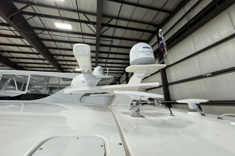 Slide: The Image of 2020 Tiara Yachts C49 Coupe in a warehouse, showcasing radar and satellite equipment. - 68