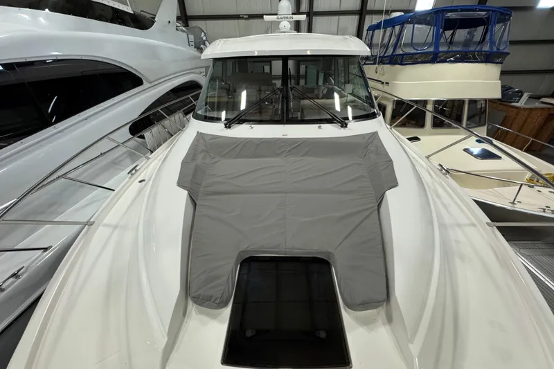 Slide: The Image of 2020 Tiara Yachts C49 Coupe in a marina, showcasing sleek design and modern features. - 70
