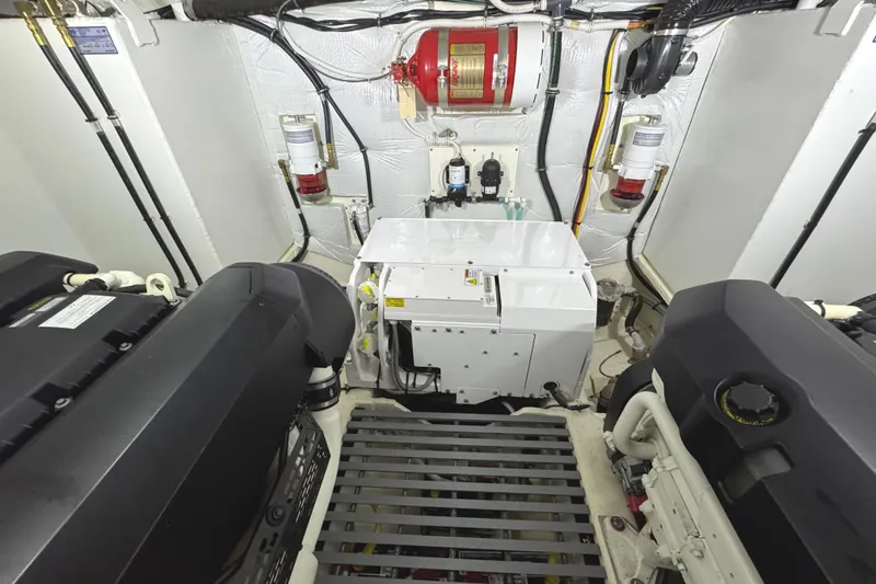 Slide: The Image of Engine room of 2020 Tiara Yachts C49 Coupe, featuring dual engines and fire suppression system. - 74