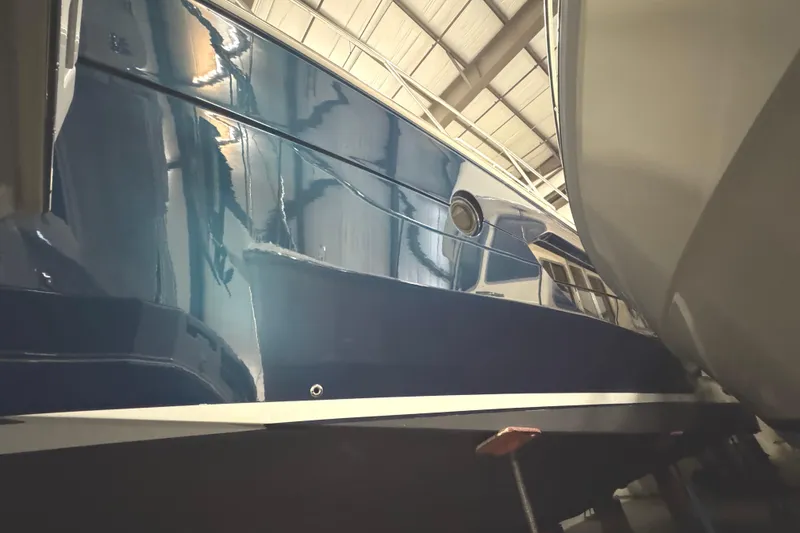 Slide: The Image of 2020 Tiara Yachts C49 Coupe in a storage facility, showcasing sleek blue hull design. - 77