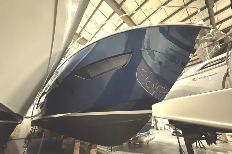 Slide: The Image of 2020 Tiara Yachts C49 Coupe in storage, showcasing sleek blue hull design. - 78