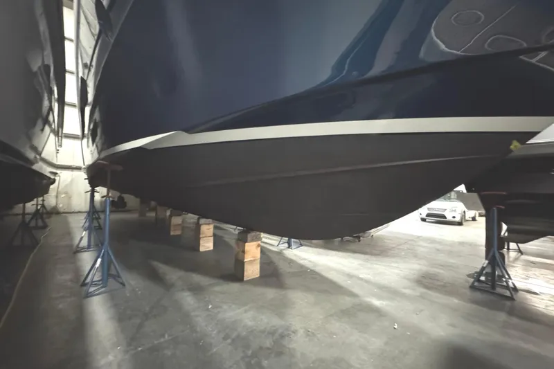 Slide: The Image of 2020 Tiara Yachts C49 Coupe in storage, supported by stands and blocks. - 79
