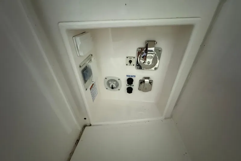 Slide: The Image of Control panel on 2020 Tiara Yachts C49 Coupe, featuring water and electrical connections. - 8