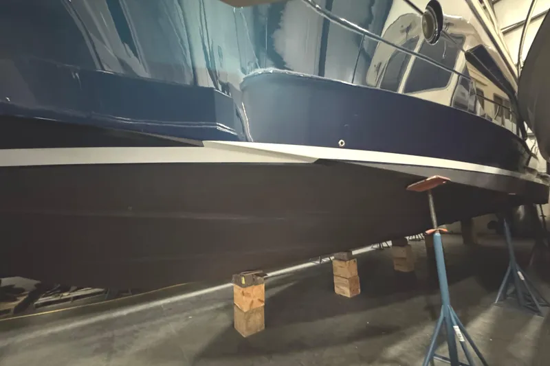 Slide: The Image of 2020 Tiara Yachts C49 Coupe in storage, supported by stands and blocks. - 80