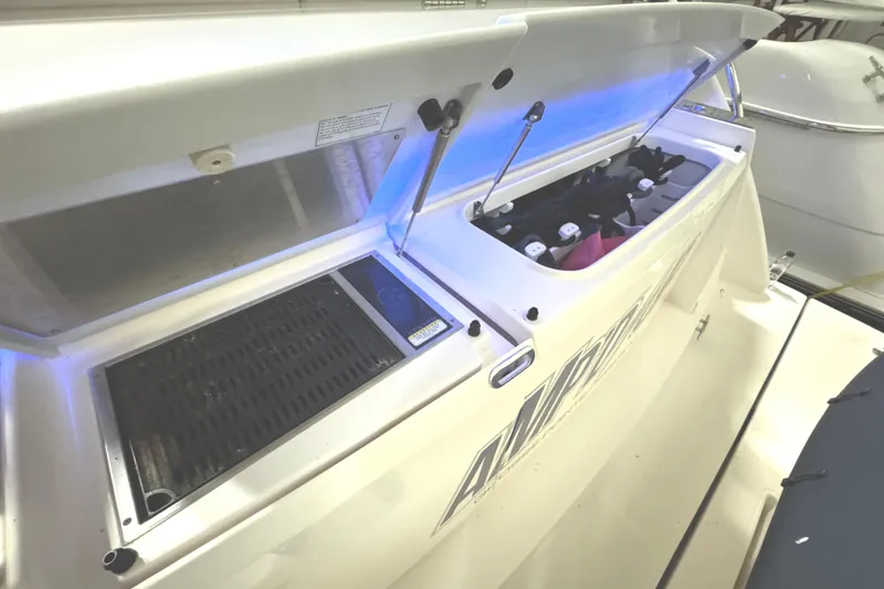 Slide: The Image of 2020 Tiara Yachts C49 Coupe with open storage compartment and grill on deck. - 9