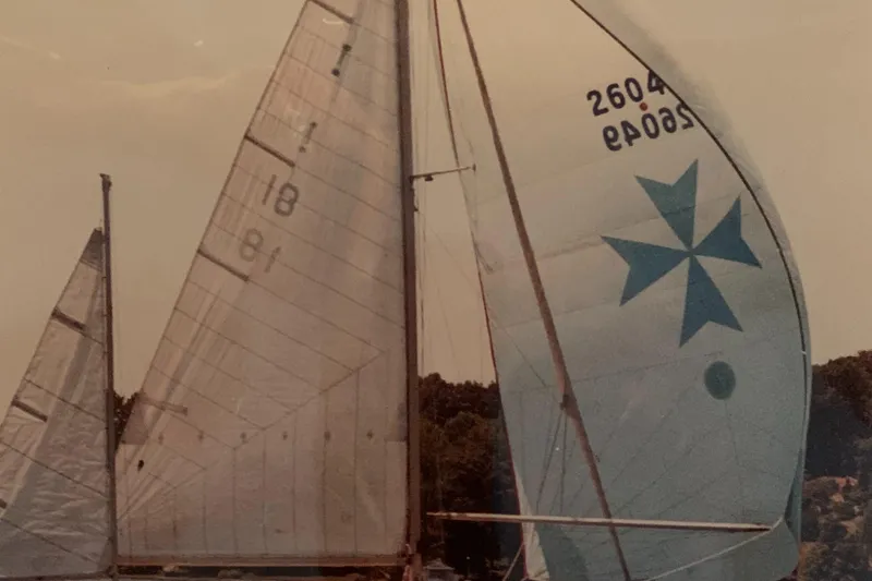 Slide: The Image of Sailboat with white sails and blue star emblem, Pearson 38, 1963 model. - 2