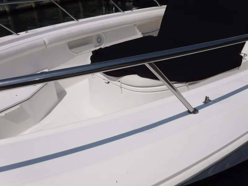 Slide: The Image of 2014 Boston Whaler 370 Outrage boat deck with railing and seating area. - 20