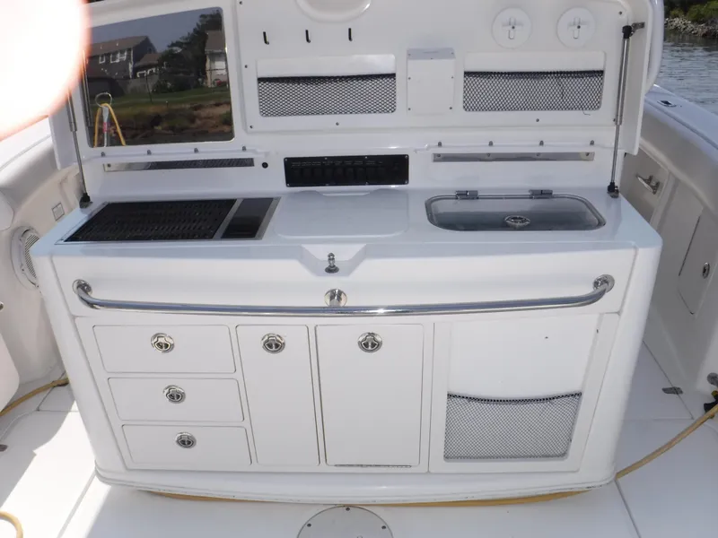 Slide: The Image of 2014 Boston Whaler 370 Outrage boat galley with sink, storage, and grill. - 23