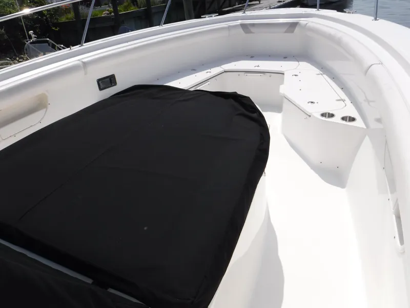 Slide: The Image of 2014 Boston Whaler 370 Outrage boat interior with black cover and white seating area. - 27