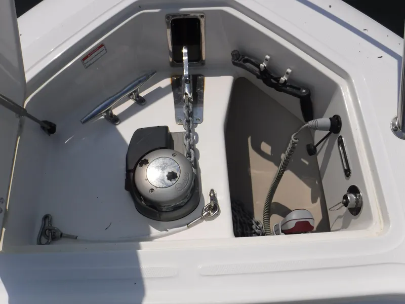 Slide: The Image of Anchor compartment of 2014 Boston Whaler 370 Outrage boat, featuring winch and chain. - 29