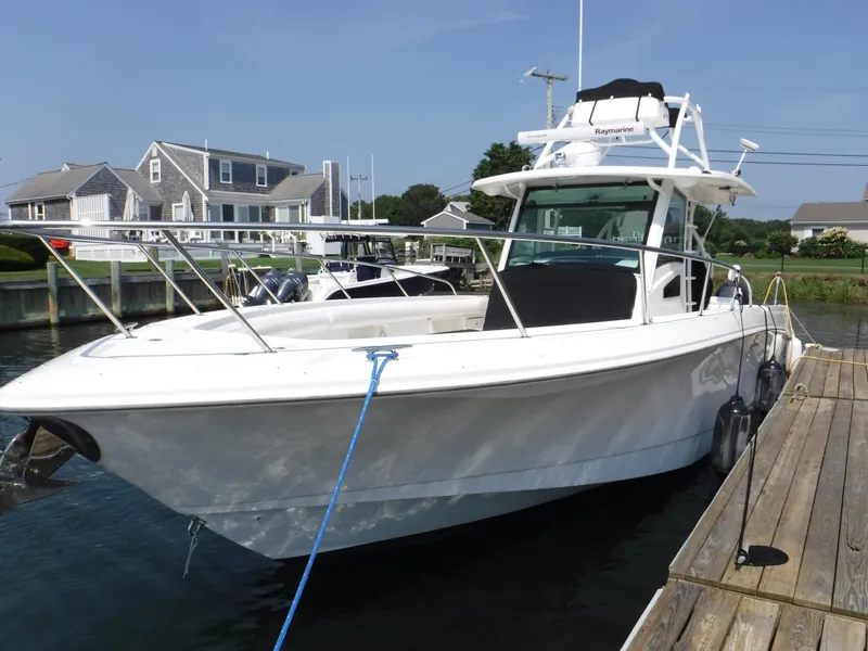 Slide: The Image of 2014 Boston Whaler 370 Outrage docked near coastal homes. - 3