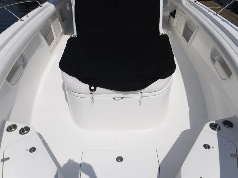 Slide: The Image of 2014 Boston Whaler 370 Outrage boat interior with black seat cover and white deck. - 30