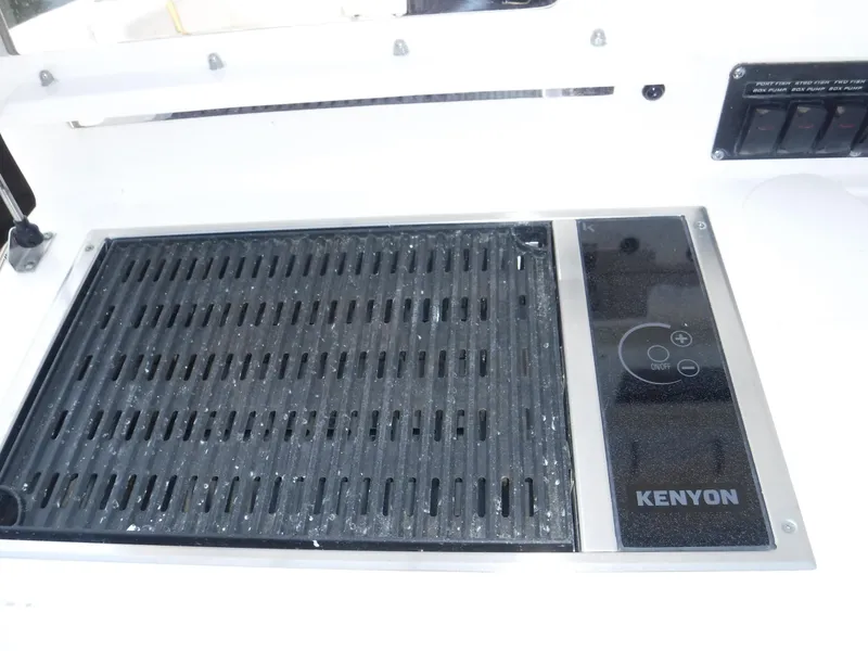 Slide: The Image of Kenyon grill on 2014 Boston Whaler 370 Outrage boat, featuring sleek design and controls. - 34