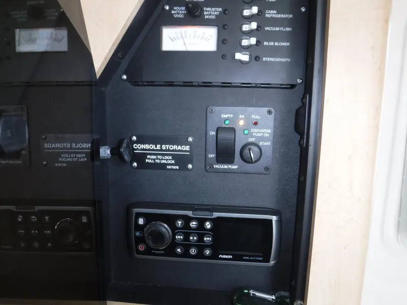 Slide: The Image of Control panel of a 2014 Boston Whaler 370 Outrage boat with various switches and gauges. - 42