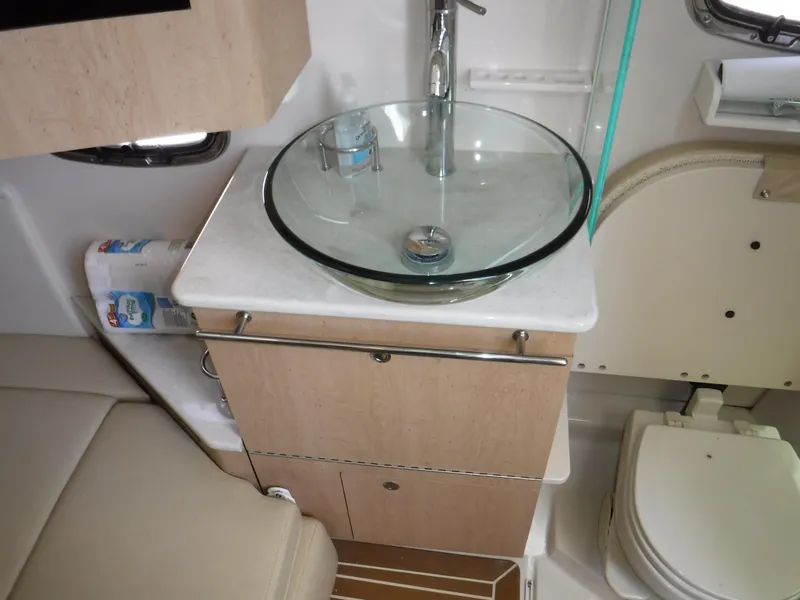 Slide: The Image of 2014 Boston Whaler 370 Outrage bathroom with glass sink, modern fixtures, and compact design. - 43