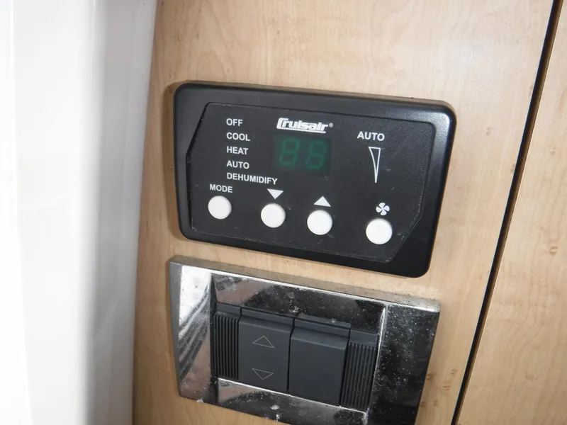 Slide: The Image of Control panel on 2014 Boston Whaler 370 Outrage boat, featuring climate settings and switches. - 45