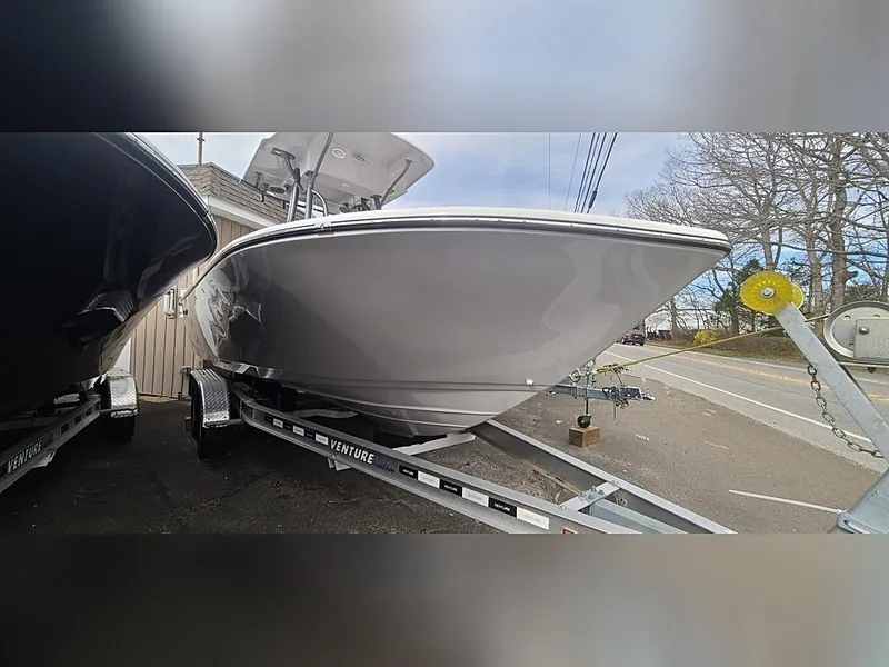 Slide: The Image of 2023 Sea Born LX22 Center Console boat on trailer, parked outdoors. - 1