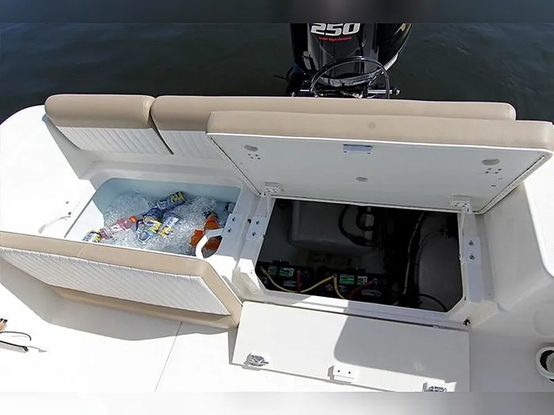 Slide: The Image of 2023 Sea Born LX22 Center Console boat with open storage compartments and visible engine. - 15