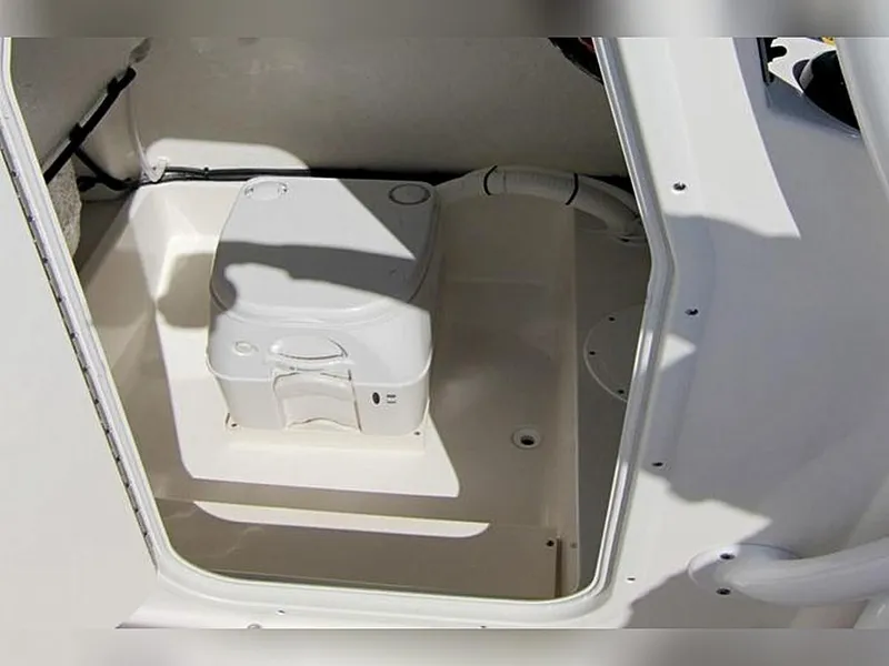 Slide: The Image of 2023 Sea Born LX22 Center Console boat interior with compact toilet. - 18