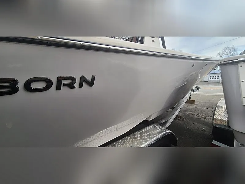 Slide: The Image of 2023 Sea Born LX22 Center Console boat side view on trailer. - 4