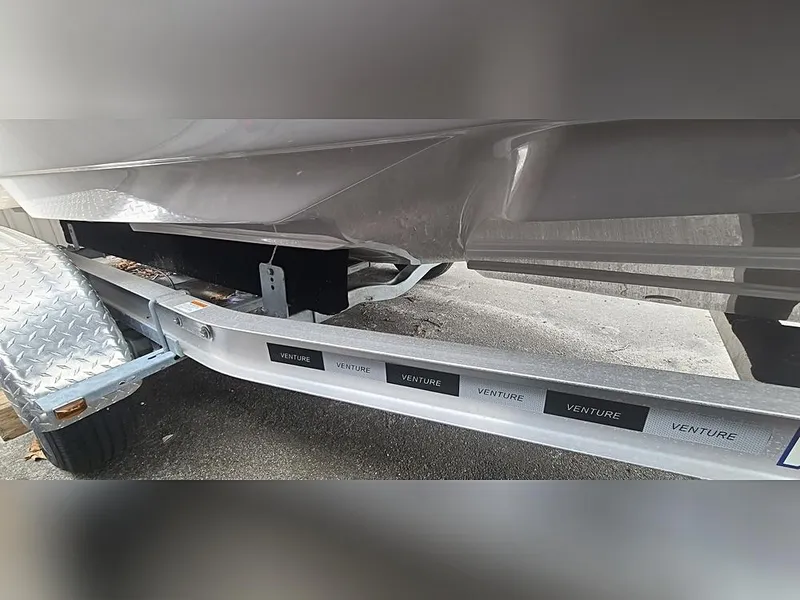 Slide: The Image of 2023 Sea Born LX22 Center Console boat on a Venture trailer, close-up view. - 5