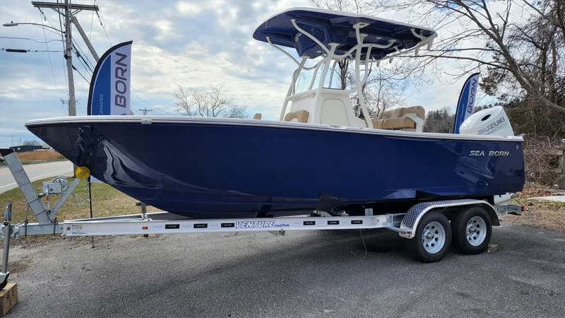 The Image of 2022 Sea Born LX22 Center Console boat on a trailer. - 0