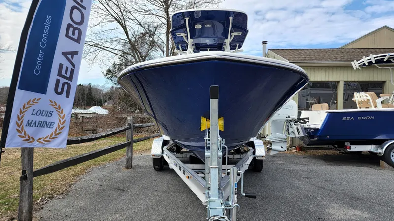 Slide: The Image of 2022 Sea Born LX22 Center Console boat on trailer at Louis Marine dealership. - 2