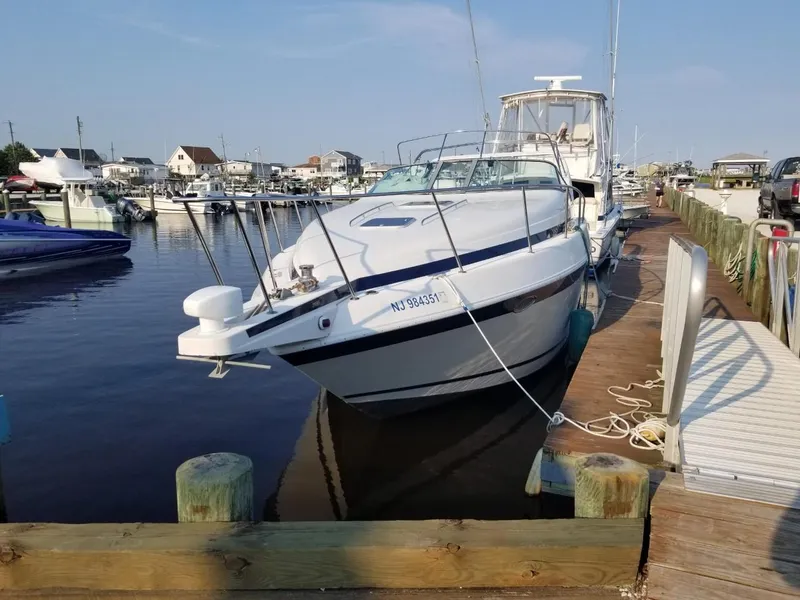 Slide: The Image of 1992 Baja 340 Motoryacht docked at a marina, clear sky, calm water. - 13