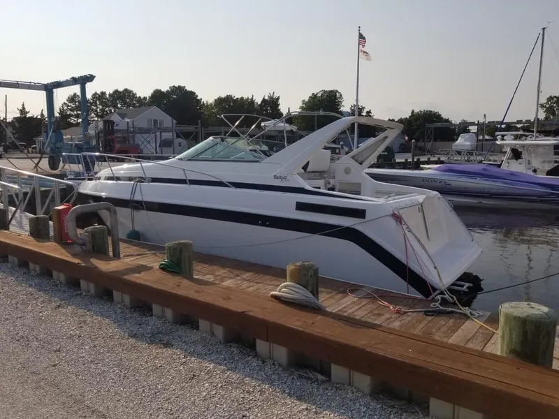 Slide: The Image of 1992 Baja 340 Motoryacht docked at a marina, side view. - 14