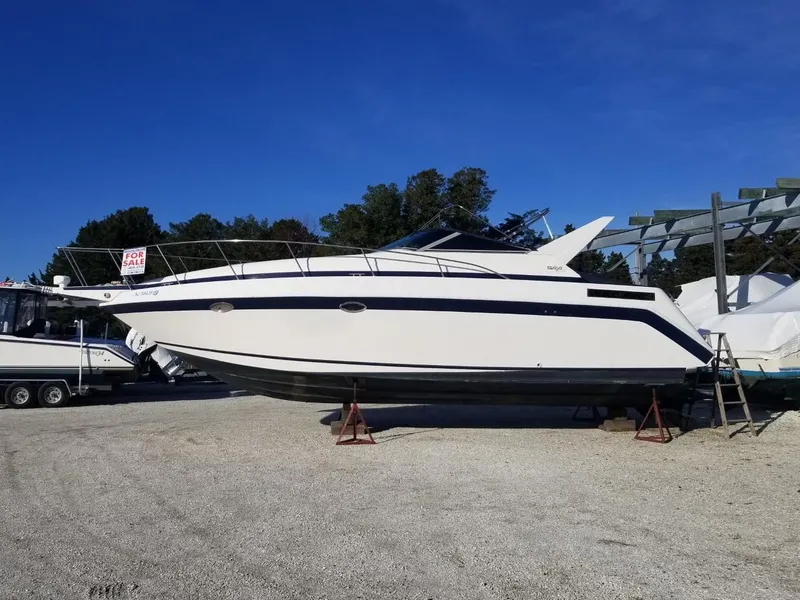Slide: The Image of 1992 Baja 340 Motoryacht on stands, for sale, under clear blue sky. - 22