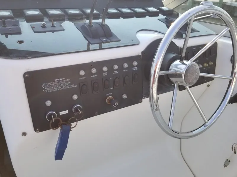 Slide: The Image of 1992 Baja 340 Motoryacht helm with steering wheel and control panel. - 25