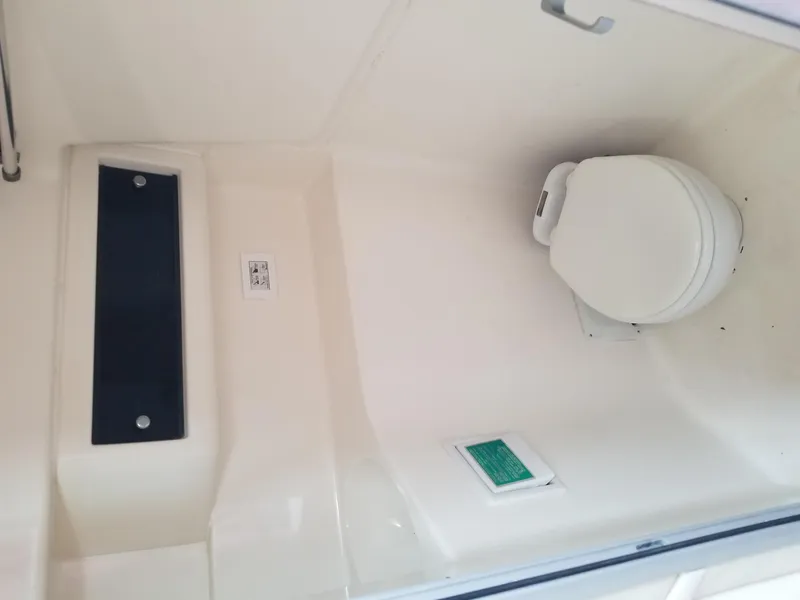 Slide: The Image of 1992 Baja 340 Motoryacht bathroom with white toilet and compact design. - 27