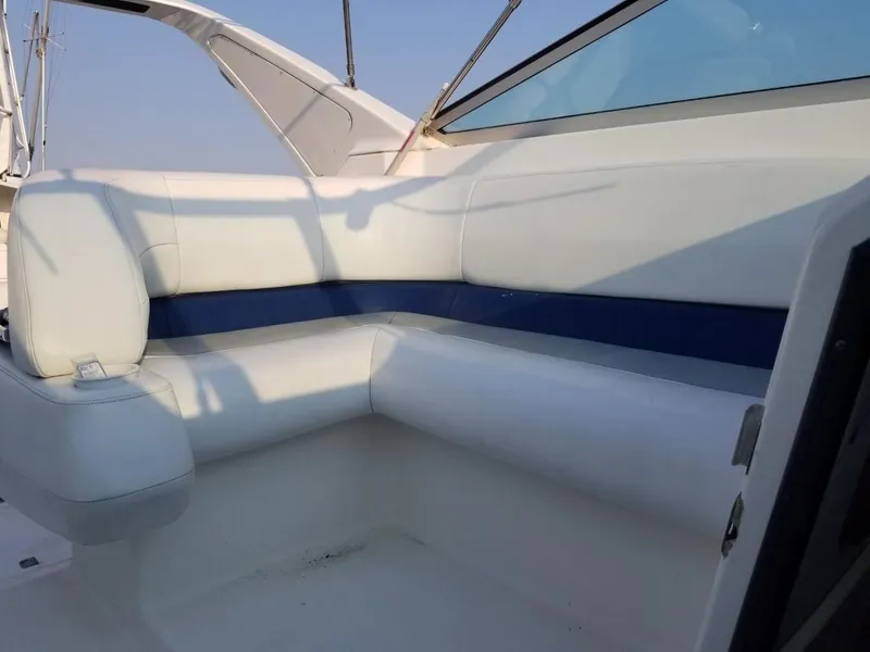 Slide: The Image of 1992 Baja 340 Motoryacht interior seating with white and blue upholstery. - 28