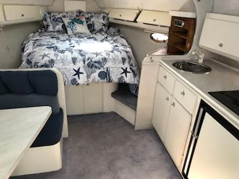 Slide: The Image of Interior of 1992 Baja 340 Motoryacht with cozy bed, kitchenette, and seating area. - 7