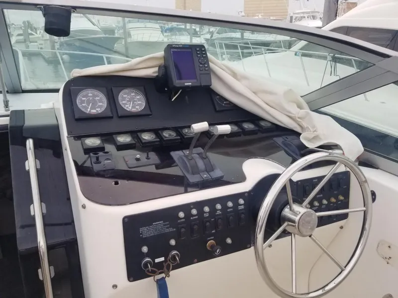 Slide: The Image of 1992 Baja 340 Motoryacht helm with steering wheel, gauges, and navigation equipment. - 8